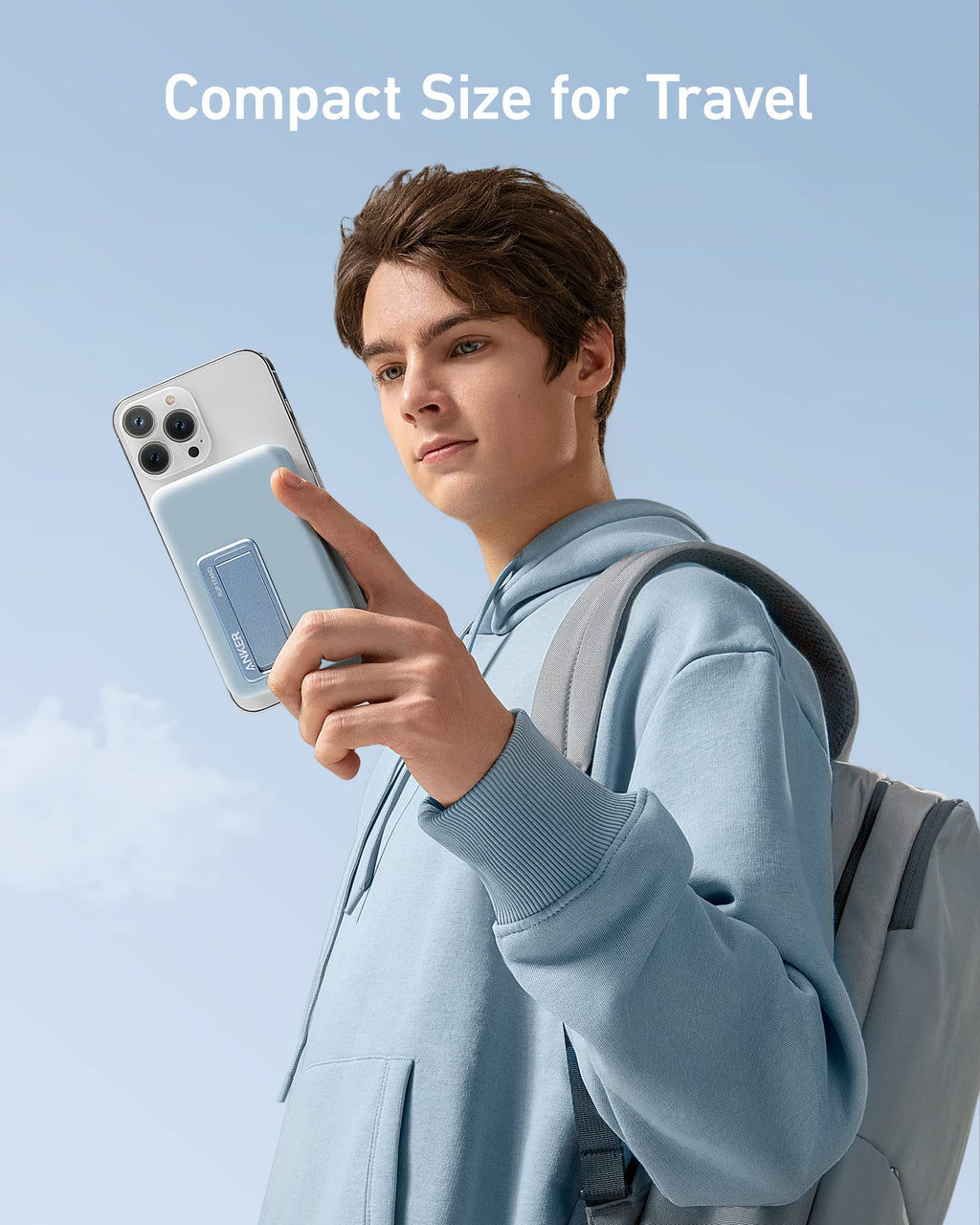 Anker with compact charger attached to iPhone held by person with backpack
